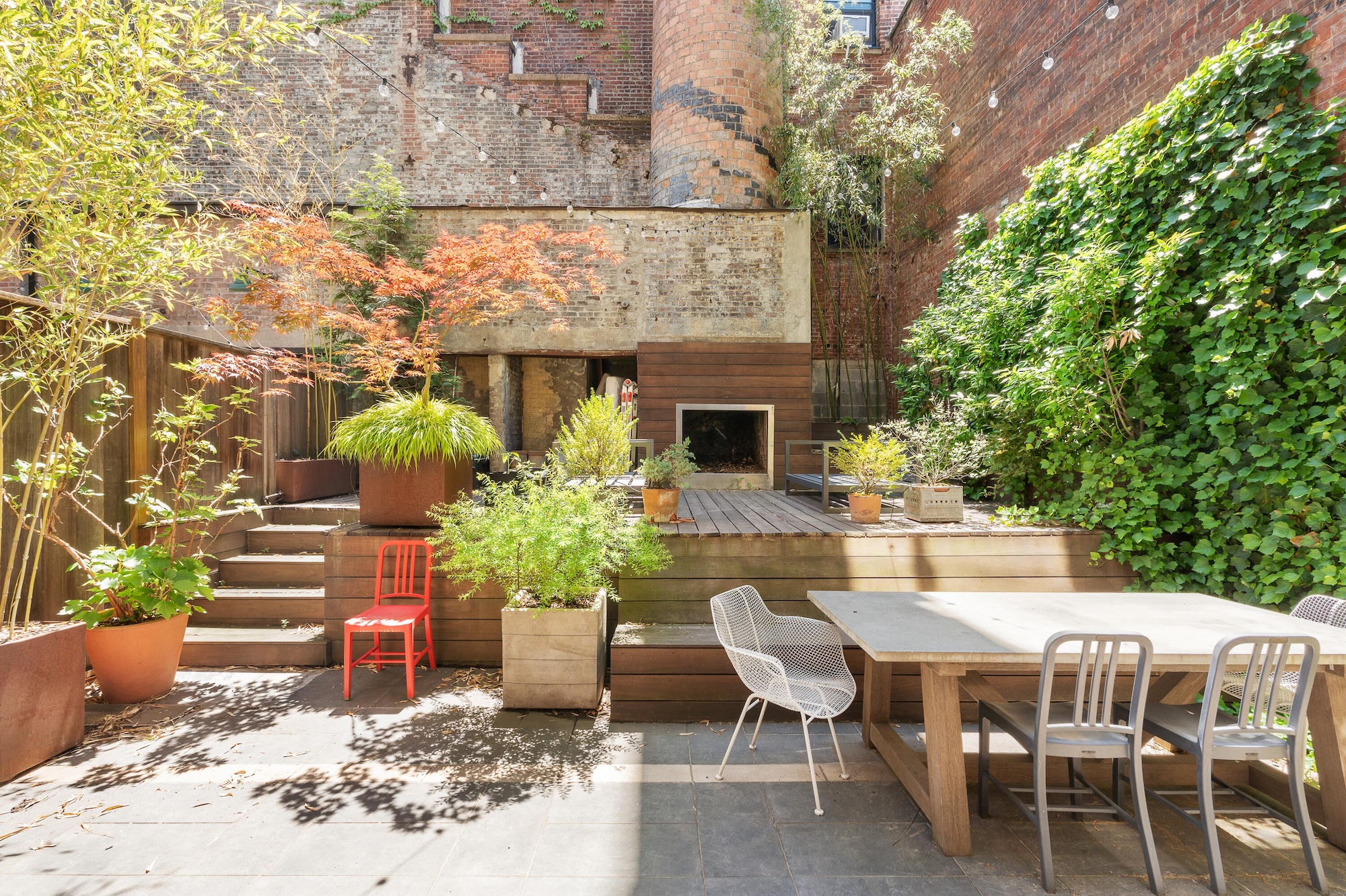 A 70-foot brick smokestack anchors a private garden at this $2.1M Williamsburg loft