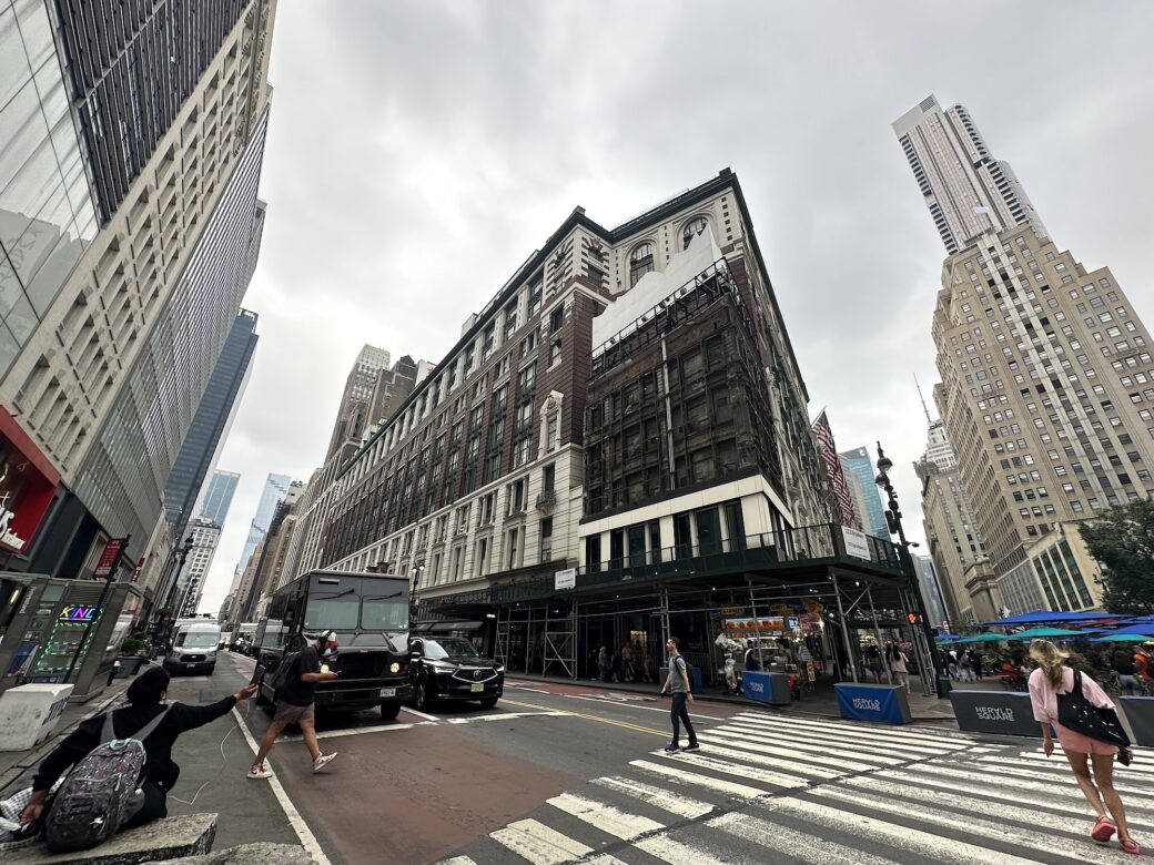 Macy’s giant shopping bag sign is removed, revealing 100-year-old building hidden for decades