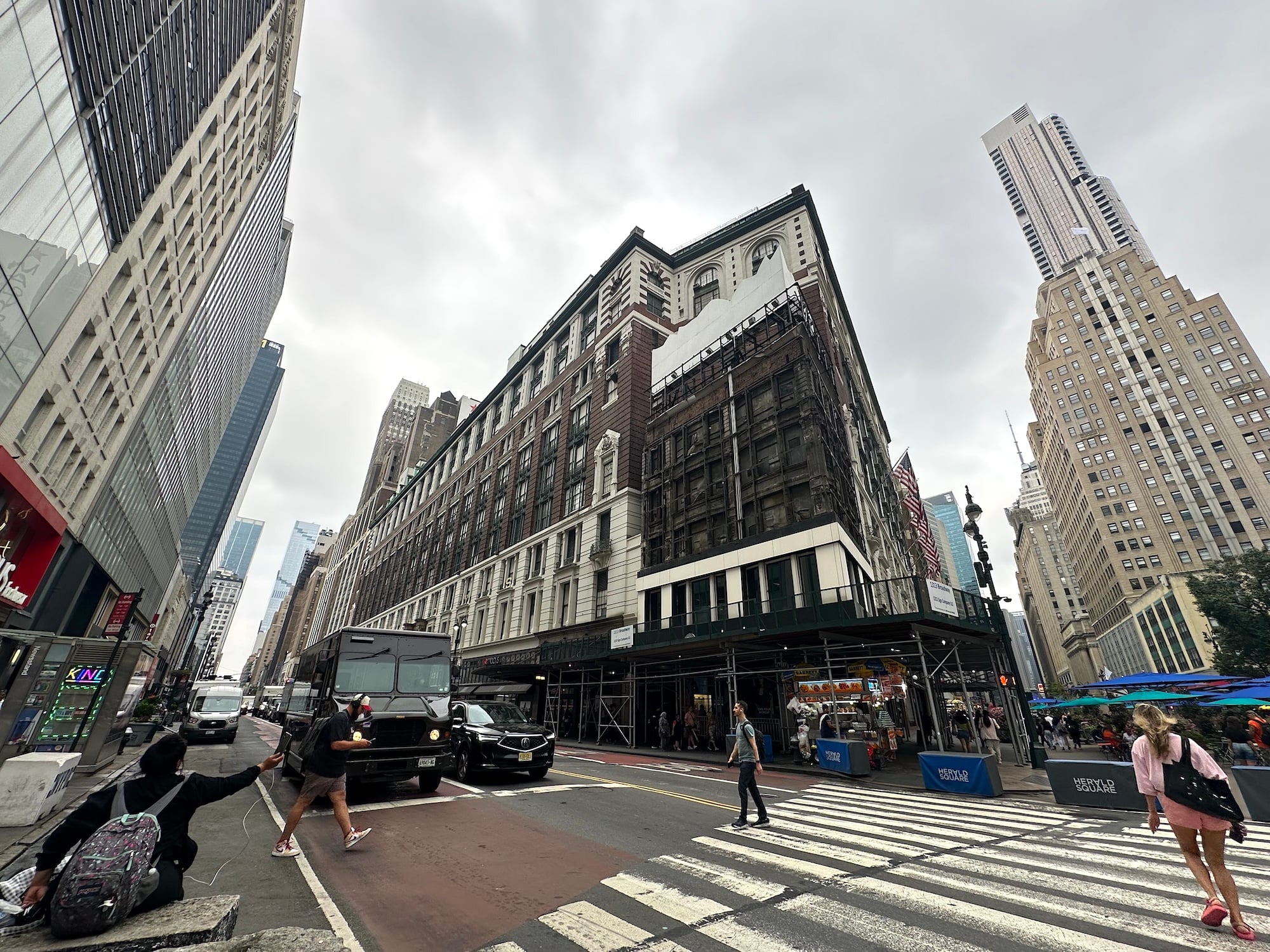 Macy's giant shopping bag sign is removed, revealing 100-year-old building hidden for decades